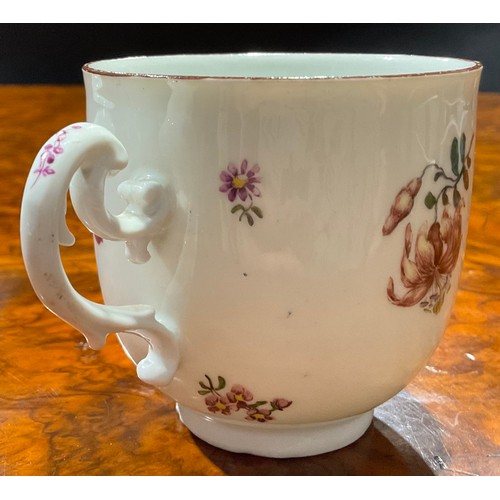 258 - A Meissen coffee cup and saucer, painted with floral bouquets and scattered flowers, brown line rims... 