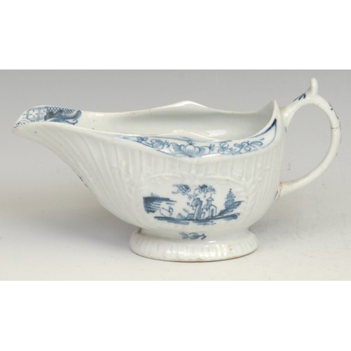 136 - A Lowestoft Little Fisherman pattern strap fluted sauce boat, decorated in underglaze blue within mo... 