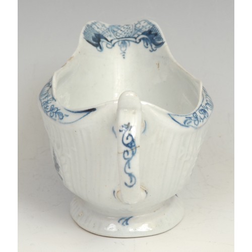 136 - A Lowestoft Little Fisherman pattern strap fluted sauce boat, decorated in underglaze blue within mo... 