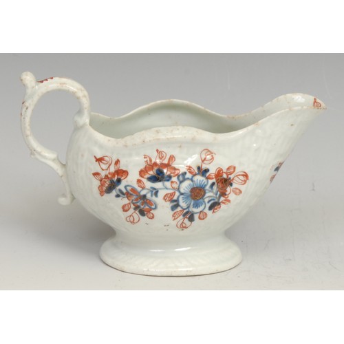 131 - A Liverpool cream boat, decorated in underglaze blue and overglaze red with flowers, picked out in g... 