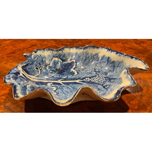 168 - A near pair of large Bow leaf shaped dishes, painted in dark blue with grape and vine, the largest 2... 