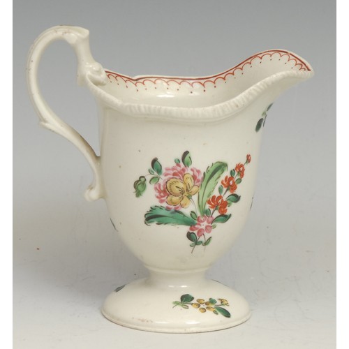 180 - A Liverpool helmet shaped pedestal cream jug, painted in polychrome with flowers, red double-line pe... 