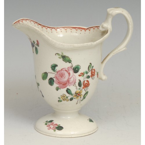 180 - A Liverpool helmet shaped pedestal cream jug, painted in polychrome with flowers, red double-line pe... 