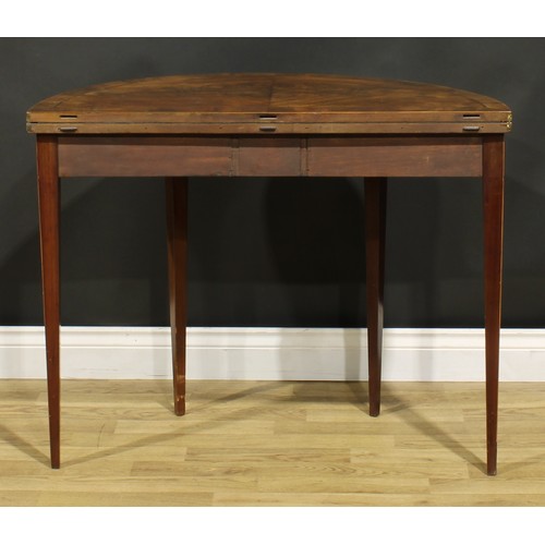 1307 - A George III mahogany demilune card table, hinged top enclosing a baize lined playing surface, taper... 