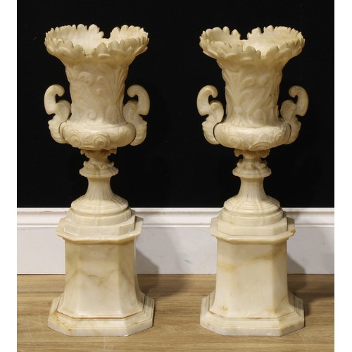 2081 - A pair of 19th century alabaster campana vases and stands, each carved with anthemions and scrolls, ... 