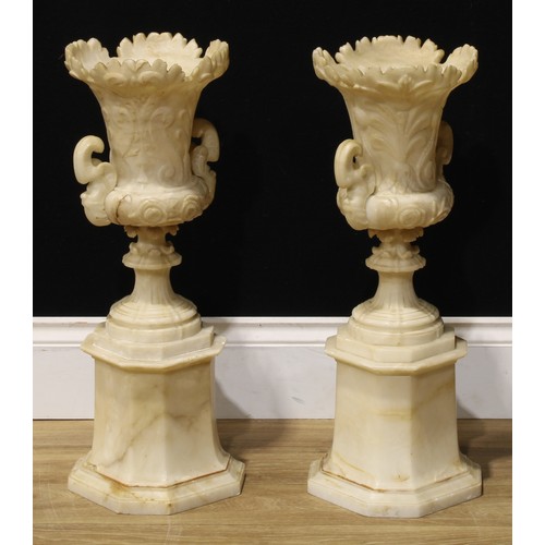 2081 - A pair of 19th century alabaster campana vases and stands, each carved with anthemions and scrolls, ... 