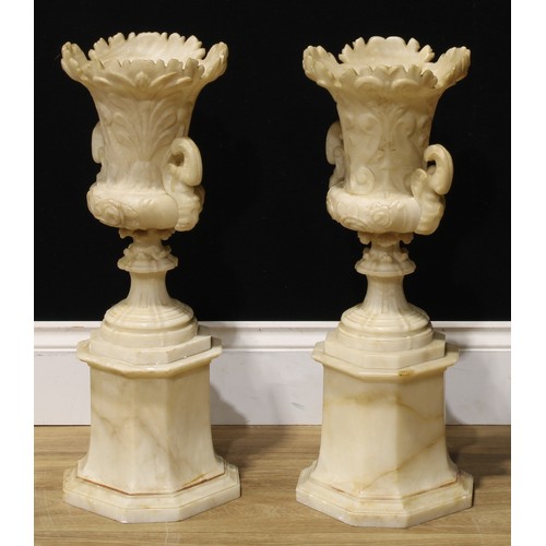 2081 - A pair of 19th century alabaster campana vases and stands, each carved with anthemions and scrolls, ... 