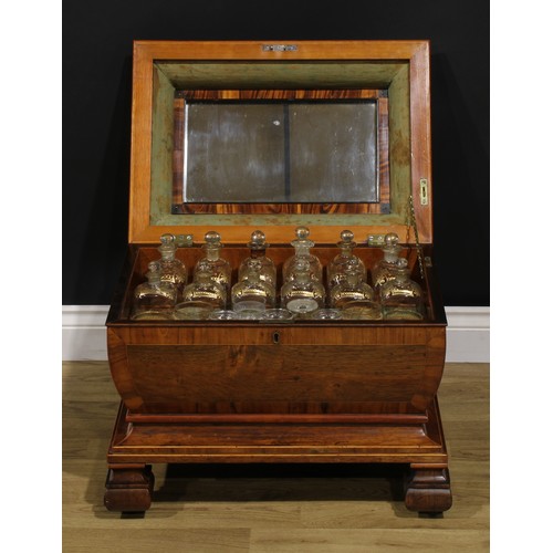 1527 - A 19th century rosewood sarcophagus liquor chest, hinged top enclosing an arrangement of parcel-gilt... 