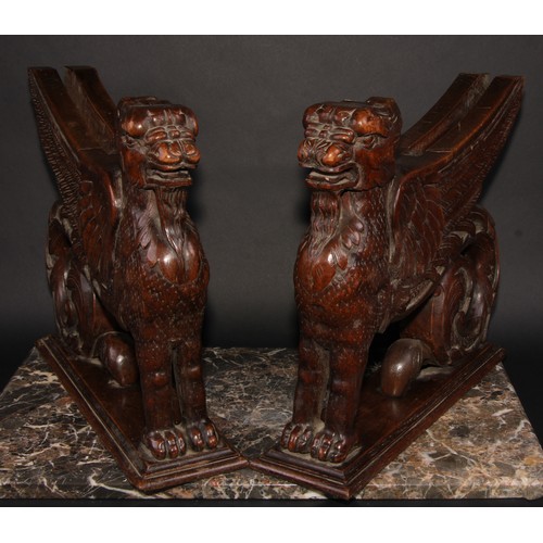 2085 - A pair of 19th century oak sculptural brackets, each carved as a gryphon, 40cm long