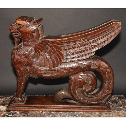 2085 - A pair of 19th century oak sculptural brackets, each carved as a gryphon, 40cm long