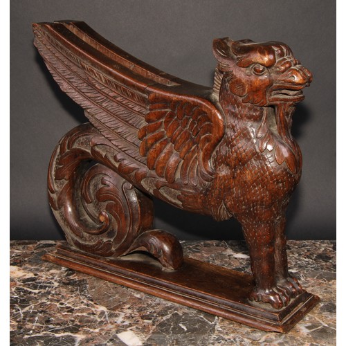 2085 - A pair of 19th century oak sculptural brackets, each carved as a gryphon, 40cm long