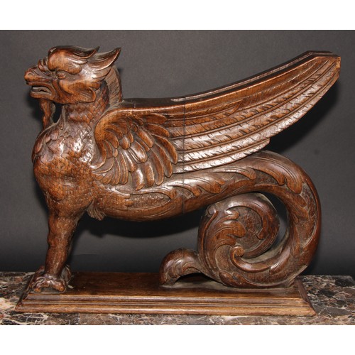 2085 - A pair of 19th century oak sculptural brackets, each carved as a gryphon, 40cm long