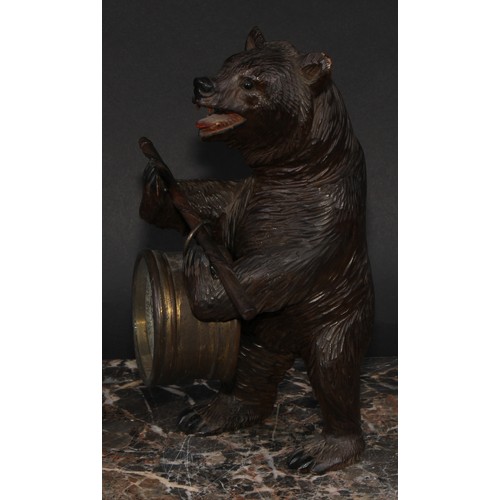 2211 - An early 20th century Black Forest carving, of a bear, holding an aneroid barometer, 21cm high