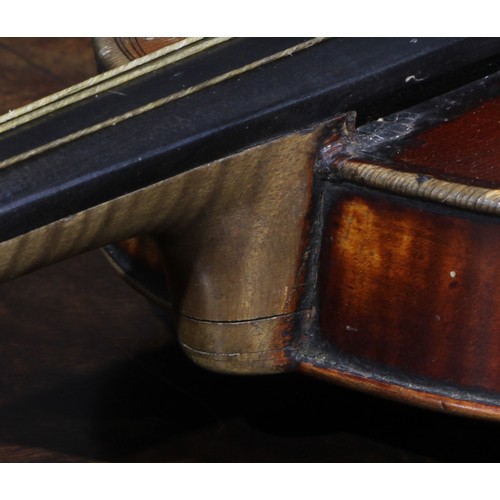 2560 - A violin, the two-piece back 35.5cm long excluding button, ebonised tuning pegs, outlined throughout... 