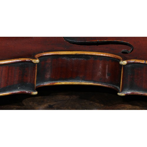 2560 - A violin, the two-piece back 35.5cm long excluding button, ebonised tuning pegs, outlined throughout... 