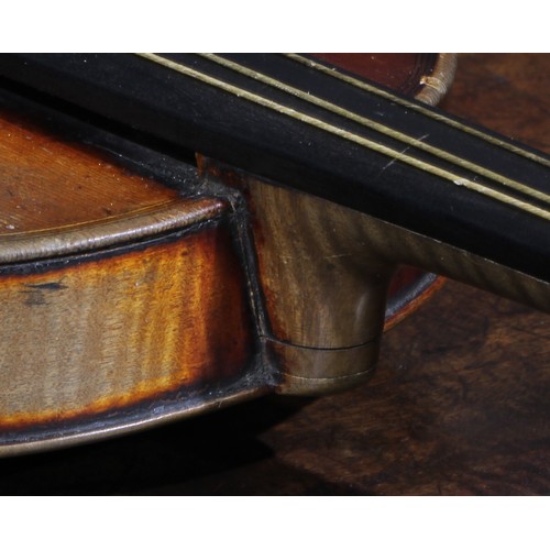 2560 - A violin, the two-piece back 35.5cm long excluding button, ebonised tuning pegs, outlined throughout... 