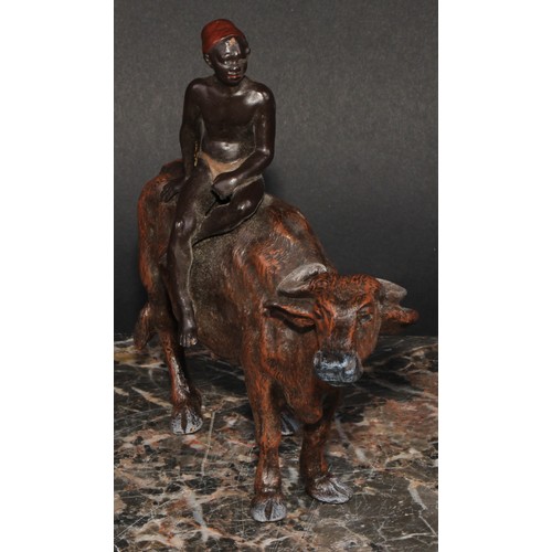 1641 - An Austrian cold painted bronze, of a North African boy riding an ox, 15cm long