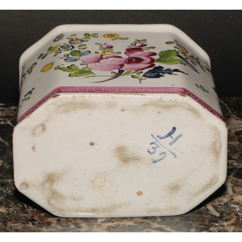 251 - A 19th century Continental faience octagonal tea caddy and cover, painted with stylised flowers, out... 