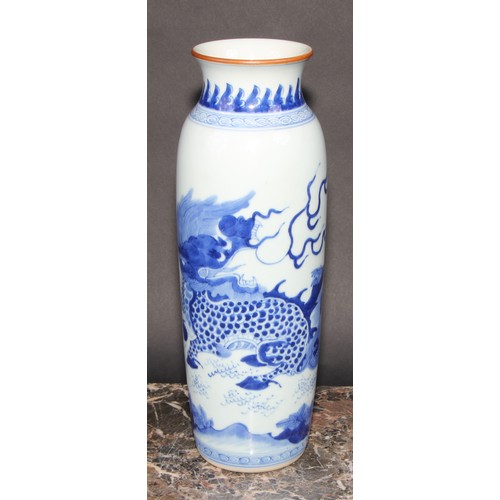 446 - A Chinese rolwagen sleeve vase, painted with a kylin and banana plants, 30cm high