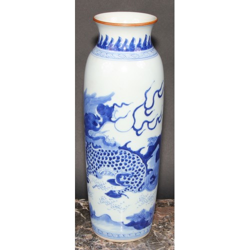 446 - A Chinese rolwagen sleeve vase, painted with a kylin and banana plants, 30cm high