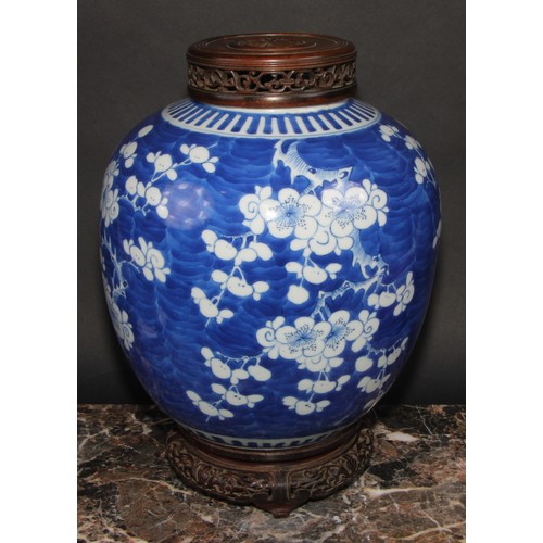 342 - A large Chinese ovoid ginger jar, painted in tones of underglaze blue with blossoming prunus on a gr... 