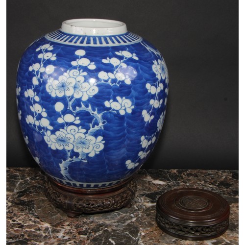 342 - A large Chinese ovoid ginger jar, painted in tones of underglaze blue with blossoming prunus on a gr... 