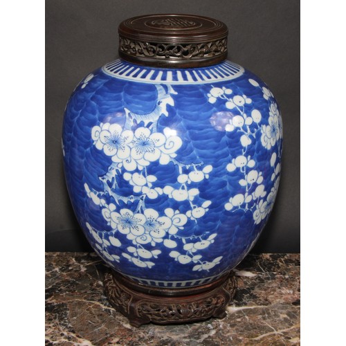 342 - A large Chinese ovoid ginger jar, painted in tones of underglaze blue with blossoming prunus on a gr... 