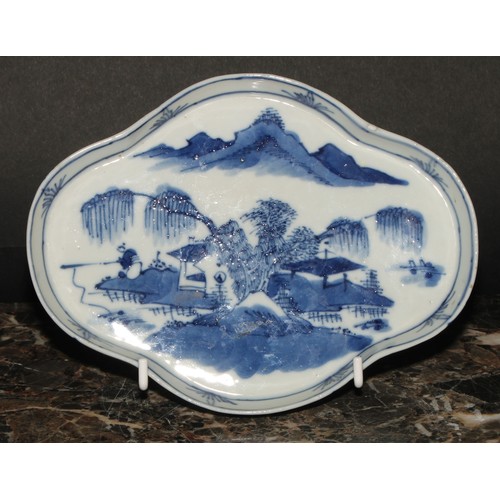 445 - A Chinese quatrefoil dish, painted in tones of underglaze blue, with a fisherman in a landscape, 19c... 