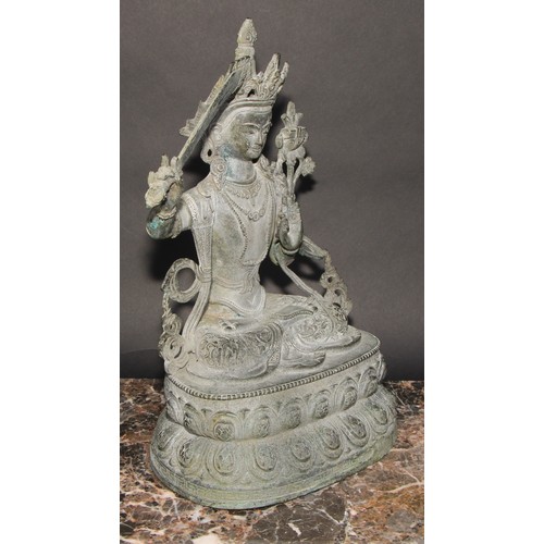 459 - Chinese School, a verdigris patinated bronze, Tara, lotus base, 38cm high