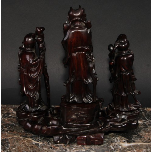 361 - A Chinese hardwood arrangement of figures, carved as Shou-Lao and immortals, 22cm wide