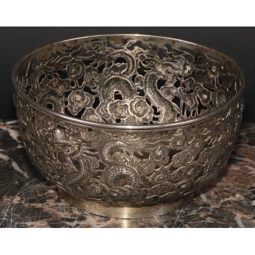 540 - A Chinese silver bowl, pierced and chased with dragons amongst scrolling clouds, 11cm diameter, Ing ... 