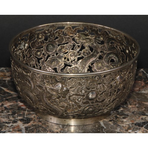 540 - A Chinese silver bowl, pierced and chased with dragons amongst scrolling clouds, 11cm diameter, Ing ... 