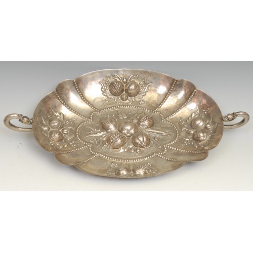 554 - A Continental silver fluted oval fruit dish, in the 17th century taste, grotesque mask handles, 39cm... 