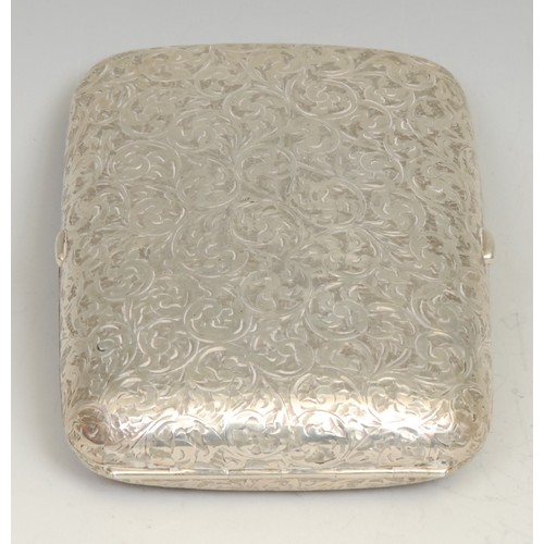 799 - An Edwardian silver rounded rectangular twin-cover cigar case, profusely engraved with scrolling fol... 