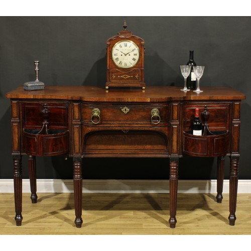 2202 - An unusual Regency mahogany sideboard or serving table, slightly oversailing top above a central fri... 