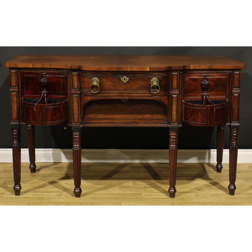 2202 - An unusual Regency mahogany sideboard or serving table, slightly oversailing top above a central fri... 