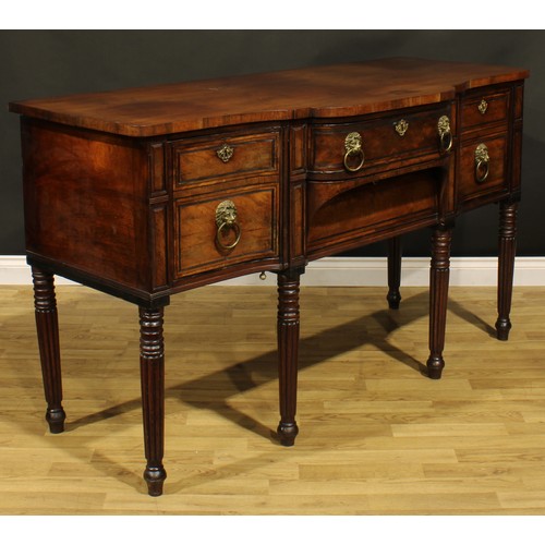 2202 - An unusual Regency mahogany sideboard or serving table, slightly oversailing top above a central fri... 