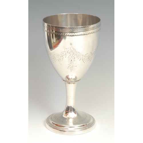 594 - A George III silver pedestal goblet, hemi-ovoid bowl, bright-cut engraved with swags and and motifs ... 