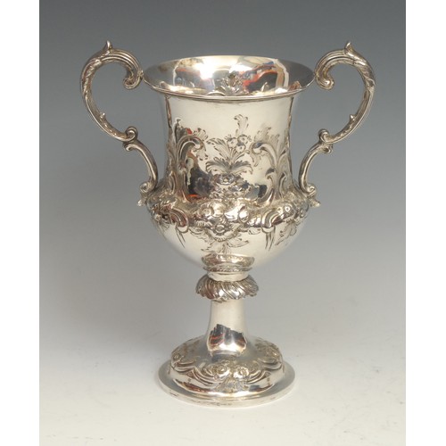 839 - Motoring Interest - a Victorian silver pedestal campana cup, chased with flowers and leafy scrolls, ... 