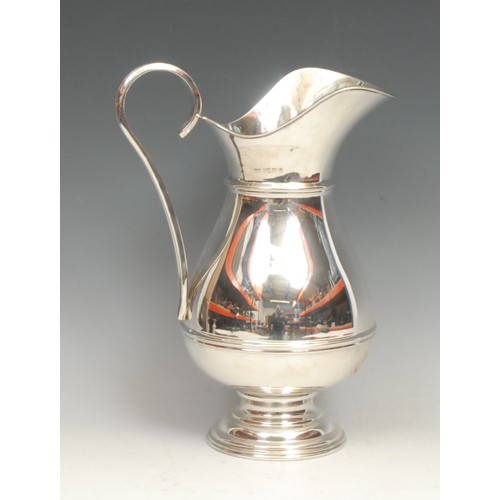 635 - A large Elizabeth II silver beer jug, in 18th century style, quite plain, three-quarter girdle, scro... 