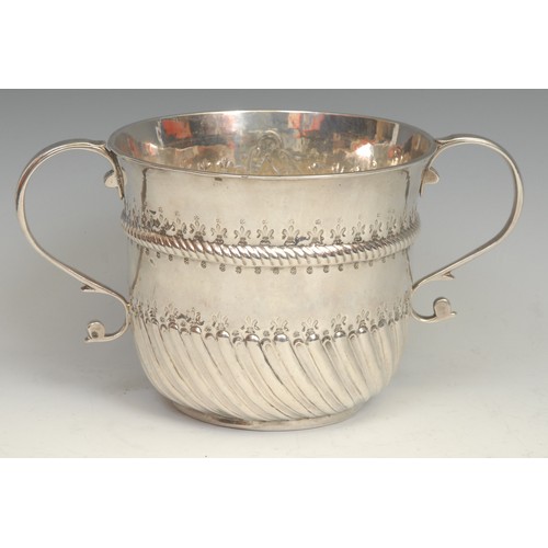 639 - A large Queen Anne silver porringer, typically half-fluted and chased, 22cm over S-scroll handles, R... 