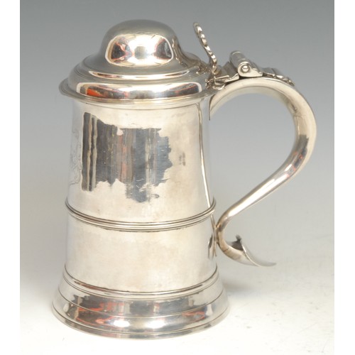 598 - A George III silver spreading cylindrical tankard, hinged domed cover, pierced chair-back thumb-piec... 