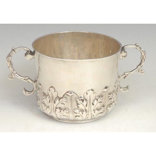 539 - A Charles II silver porringer, chased with a band of acanthus, leafy scroll handles, 15cm wide, John... 