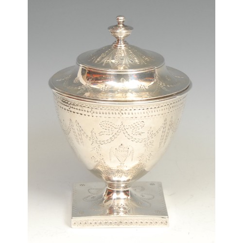 599 - A George III urnular pedestal sugar vase and cover, profusely bright-cut engraved in the Neo-Classic... 