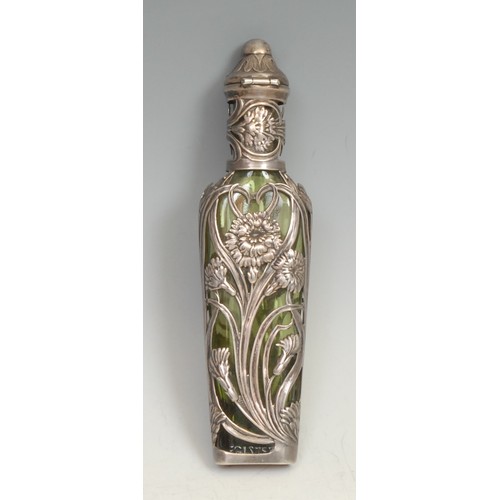 749 - An Art Nouveau silver and green glass scent bottle, the mount embossed with flowers and sinuous leav... 