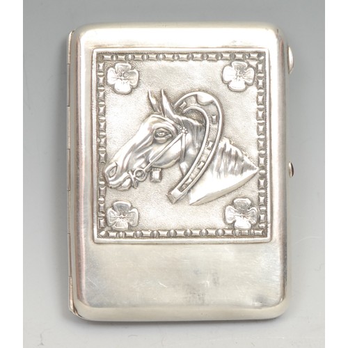 684 - A Russian silver rounded rectangular cigarette case, the hinged cover chased with a horse, gilt inte... 