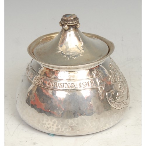 843 - Omar Ramsden - an Arts and Crafts silver tea caddy, chased with an armorial and inscribed within a b... 