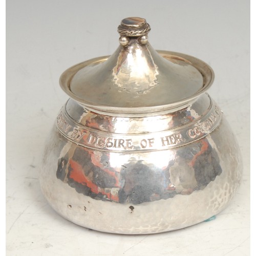 843 - Omar Ramsden - an Arts and Crafts silver tea caddy, chased with an armorial and inscribed within a b... 