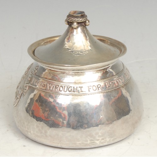 843 - Omar Ramsden - an Arts and Crafts silver tea caddy, chased with an armorial and inscribed within a b... 