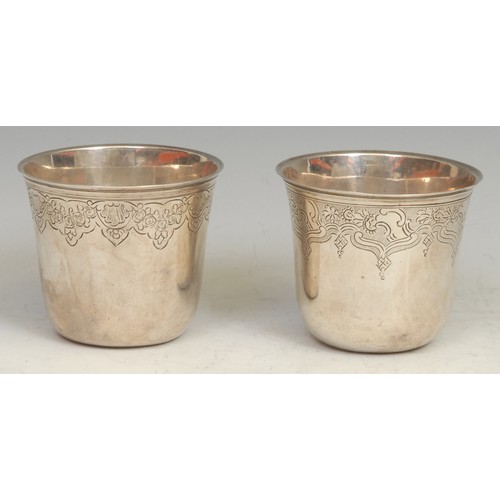 650 - A pair of 18th century French silver bell shaped beakers, chased with bands of flowers, scrolling le... 